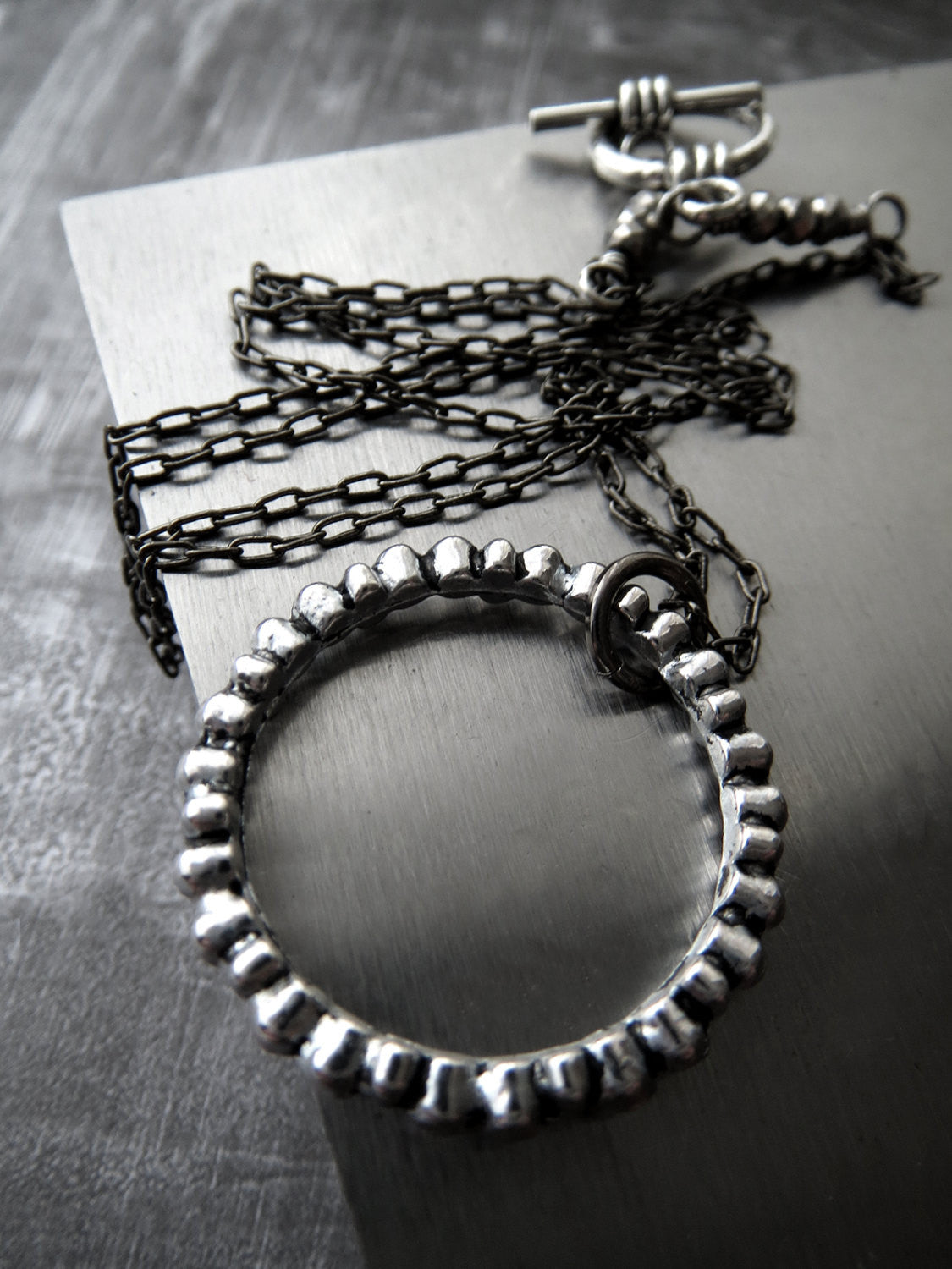Textured Silver Circle Pendant Necklace on Gunmetal Black Chain