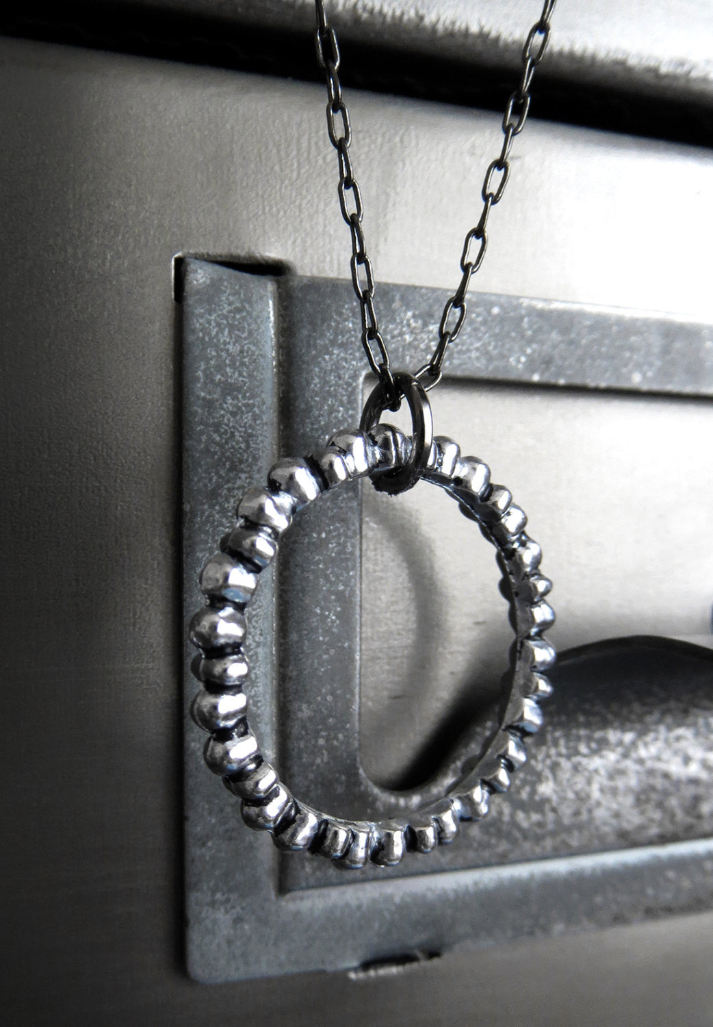 Textured Silver Circle Pendant Necklace on Gunmetal Black Chain